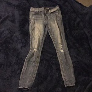 Medium wash ripped Express jeans.